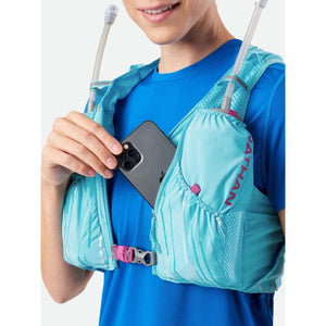 Person wearing a light blue Nathan hydration vest with a smartphone in the front pocket