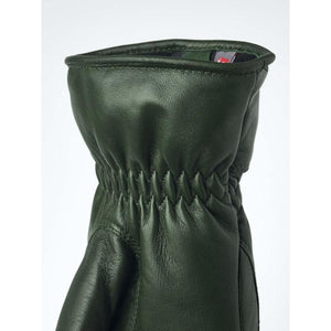 Close up of dark green leather glove cuff with gathered elastic wrist detail