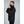 Man wearing black 8K FlexWarm heated jacket from side profile