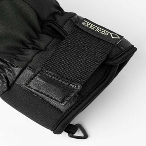 Black winter glove cuff with Gore-Tex label and adjustable velcro strap