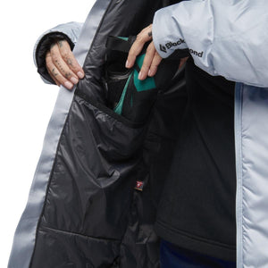 Interior view of a Black Diamond jacket showing a large drop pocket containing a climbing shoe