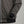 Close up of a grey bomber jacket with a silver zipper and black ribbed cuffs