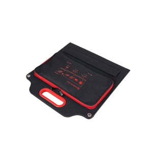 Outdoor Tech portable solar panel charger in black with red trim and integrated carry handle
