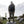 Man wearing FjallRaven vest and hiking gear standing on a rock in the mountains