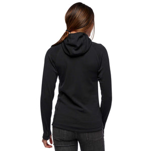 Back view of a woman wearing a black Black Diamond hooded long sleeve top