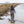 Person wearing camouflage waders walking through shallow water with duck decoys