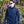 Man wearing black softshell jacket and gloves in a forest setting