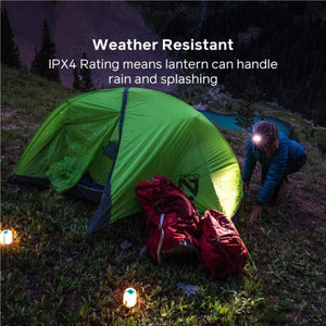 Nemo lantern placed outside a green tent at night with IPX4 weather resistant rating text overlay
