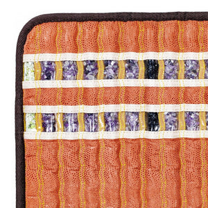 HealthyLine mat corner showing rows of embedded amethyst and tourmaline crystals