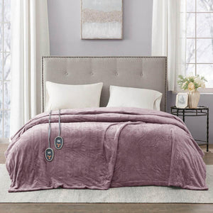 Beautyrest purple heated electric blanket with two controllers on a bed