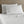 Shavel white bed sheet set with two pillows against a wooden headboard