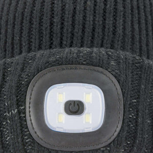 Close up of a black ribbed knit beanie with a built in LED light and power button