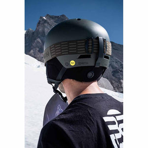 Back view of person wearing olive green Smith Optics helmet with MIPS technology in snowy mountain setting