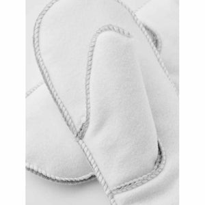 Hestra white sheepskin mittens with visible stitched seams