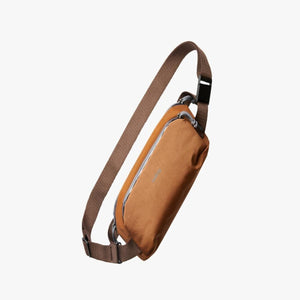 Bellroy brown sling bag with adjustable strap and zipper closure