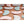Assorted pink and mint green adhesive heel cushions on a brown background