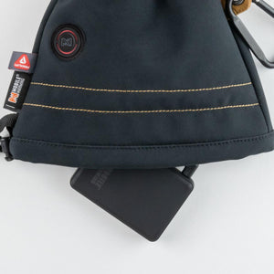 Mobile Warming black battery pack partially inserted into a dark fabric pouch with Primaloft branding