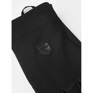 Black Hestra glove with embossed brand logo patch