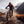 Mountain biker riding through a stream in a mountainous landscape