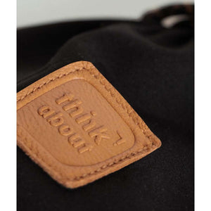 Lenz branded leather patch with embossed text think about on black fabric