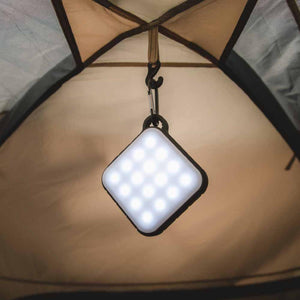 Outdoor Tech square LED camping lantern hanging from the ceiling of a tent