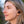 Woman wearing black Outdoor Tech wireless earbuds
