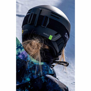 Rear view of a person wearing a black Smith Optics Method ski helmet and goggles