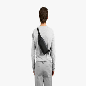 Person wearing a black Bellroy sling bag across their back