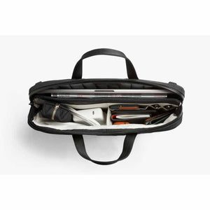 Top view of open Bellroy briefcase filled with laptop and tech accessories