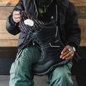 Person holding a black Baffin winter boot with a removable inner liner