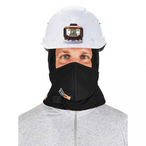 Person wearing a white hard hat with a headlamp and a black N-Ferno balaclava face mask