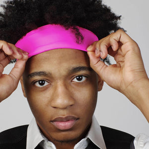 Person wearing a bright pink Oro Sports headband
