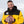 Man wearing a yellow and black ActionHeat Pittsburgh Steelers jacket holding a football