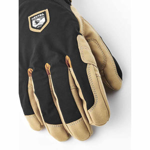 Hestra black and tan leather glove with brand logo patch