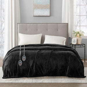 Beautyrest black heated blanket with dual controllers draped over a bed