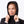 Woman wearing a black hooded jacket with hands pulling the hood edges