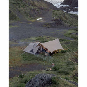 Snow Peak tent and tarp setup on a grassy coastal cliffside