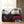 Two folded plaid heated blankets with sherpa lining and a remote control on a wooden surface