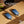 Two Ocoopa hand warmers being charged simultaneously with a USB-C cable on a wooden surface