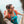 Woman wearing a Salewa backpack and tank top climbing rocks near water
