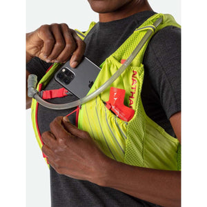 Person wearing a neon yellow Nathan hydration vest with a smartphone and energy gel in the front pockets