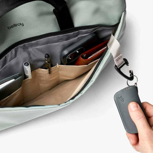 Bellroy bag interior with organized pockets containing pens phone and wallet with a key clip attached