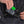 Person inserting a Black Diamond avalanche transceiver into a chest harness pocket