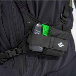 Black Diamond beacon stored in a chest harness pocket