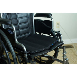 Black Invacare wheelchair seat cushion on a wheelchair