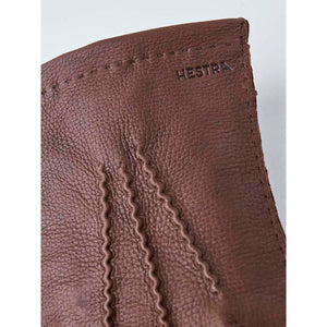 Brown Hestra leather glove detail with visible stitching