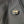 Close up of a black and orange heated jacket power button with a logo