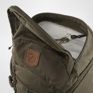Open top compartment of a dark green Fjallraven backpack showing a key ring attachment