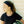 Girl wearing Oro Sports black headband and athletic shirt holding a soccer ball