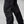 Close up of black technical outdoor trousers with zippered pockets and reinforced knee panels